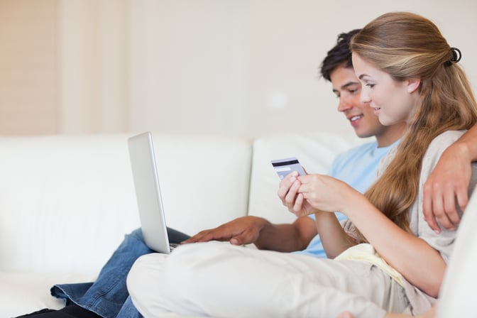 Couple shopping online in their living room-1